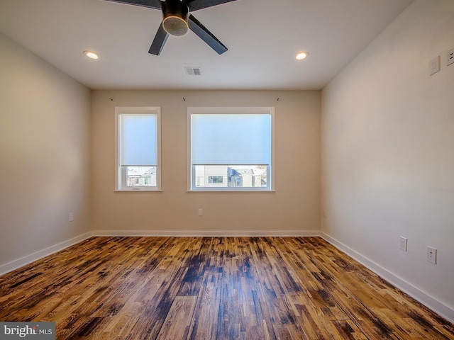 unfurnished room featuring dark wood-type flooring and ceiling fan