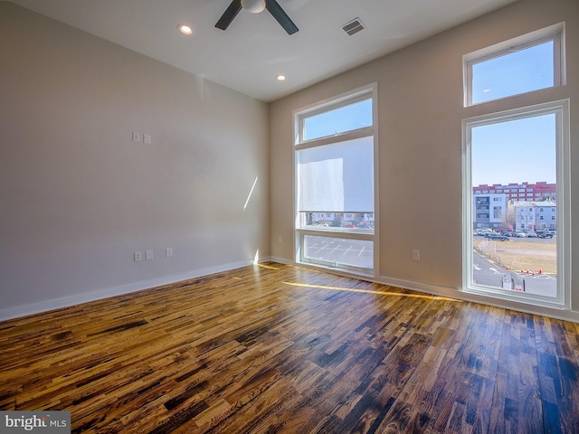 empty room featuring ceiling fan and dark hardwood / wood-style flooring