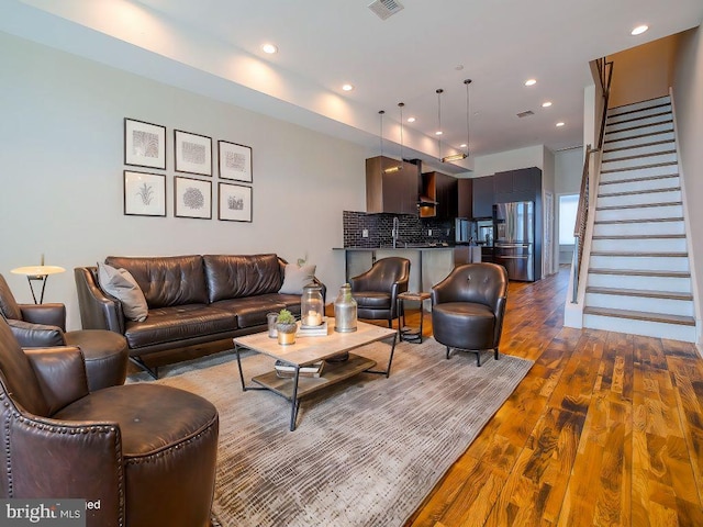 living room featuring sink and hardwood / wood-style flooring