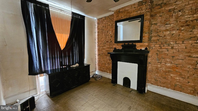 living room with crown molding, ceiling fan, and brick wall