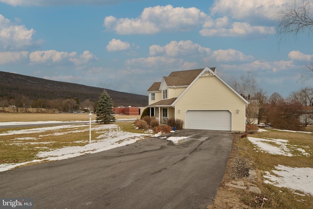 view of front of house featuring a garage and a mountain view