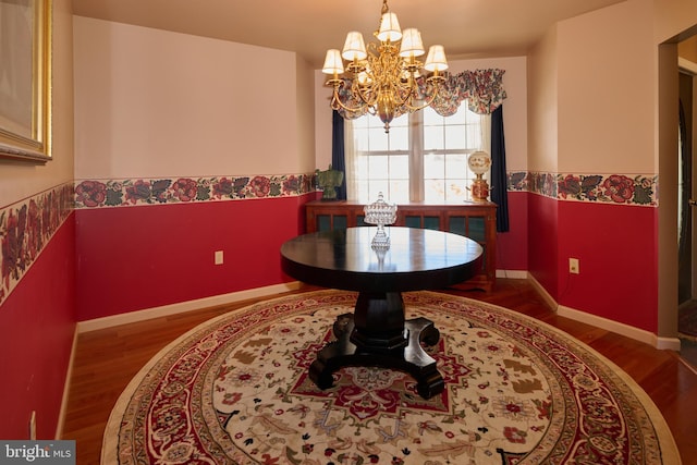 dining room with an inviting chandelier and hardwood / wood-style floors