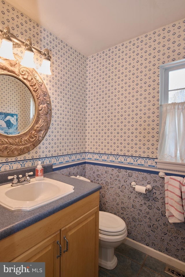 bathroom with vanity, tile patterned floors, and toilet