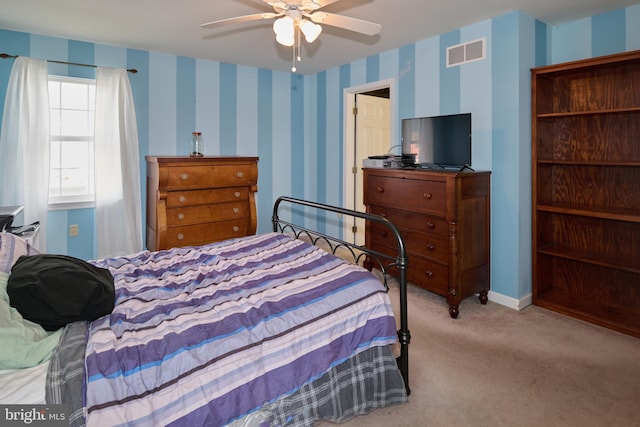 bedroom with light colored carpet and ceiling fan