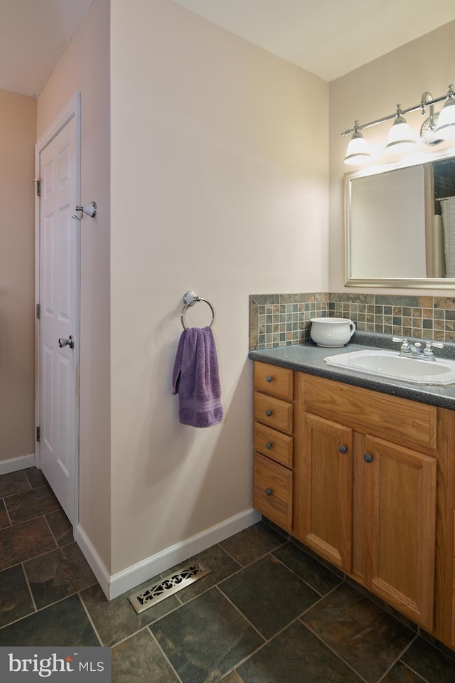 bathroom featuring tasteful backsplash and vanity