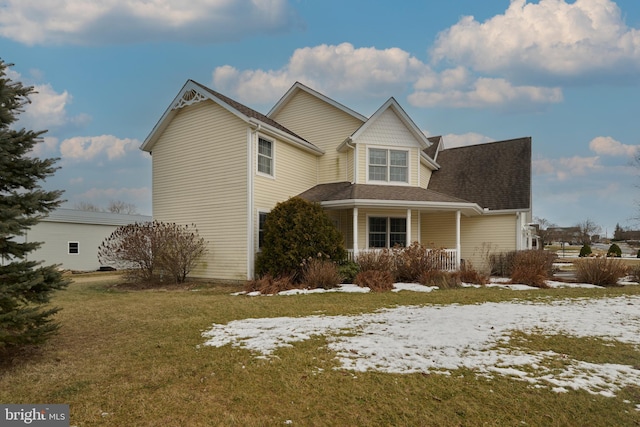 view of front facade with a porch and a yard