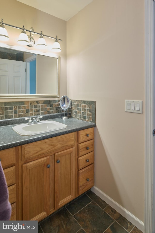 bathroom with tasteful backsplash and vanity