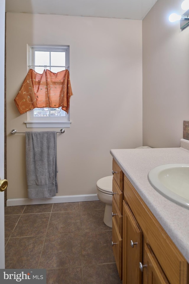 bathroom with tile patterned floors, vanity, and toilet