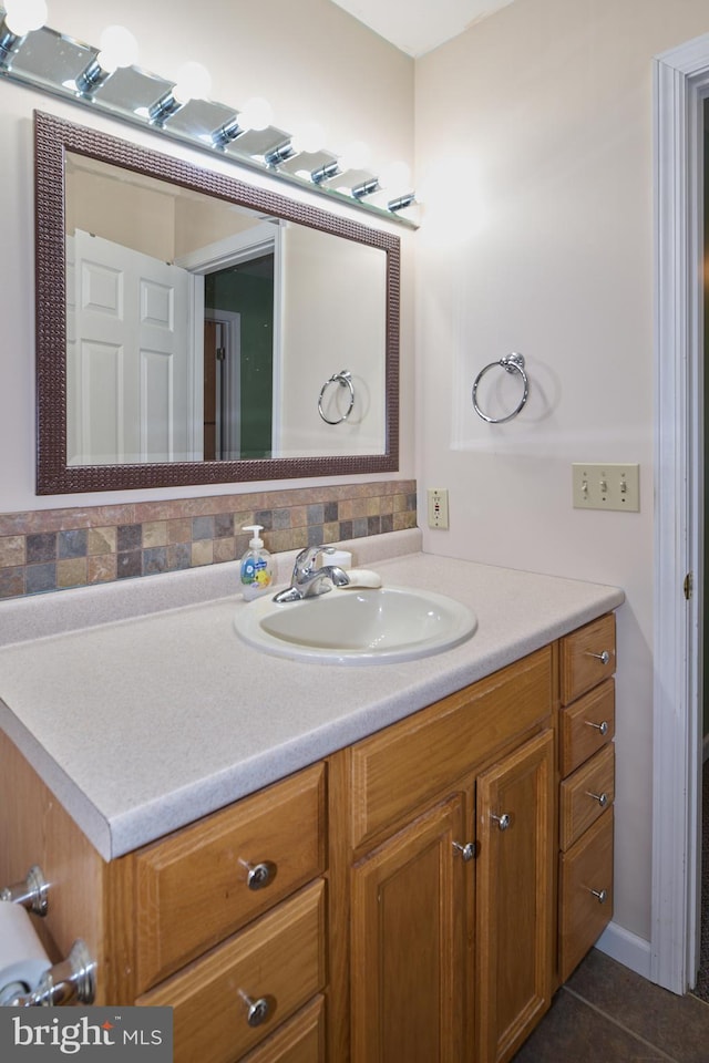 bathroom featuring vanity, tasteful backsplash, and tile patterned floors