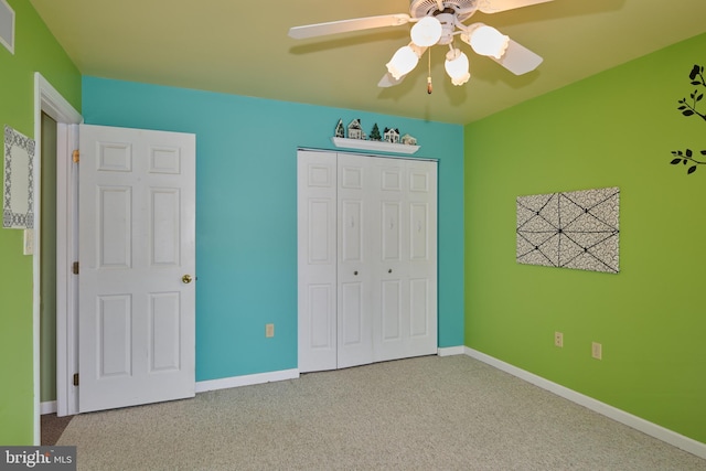 unfurnished bedroom featuring light carpet, a closet, and ceiling fan