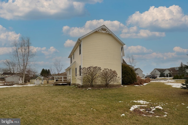 view of property exterior featuring a wooden deck and a yard