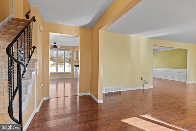 interior space with wood-type flooring and ceiling fan