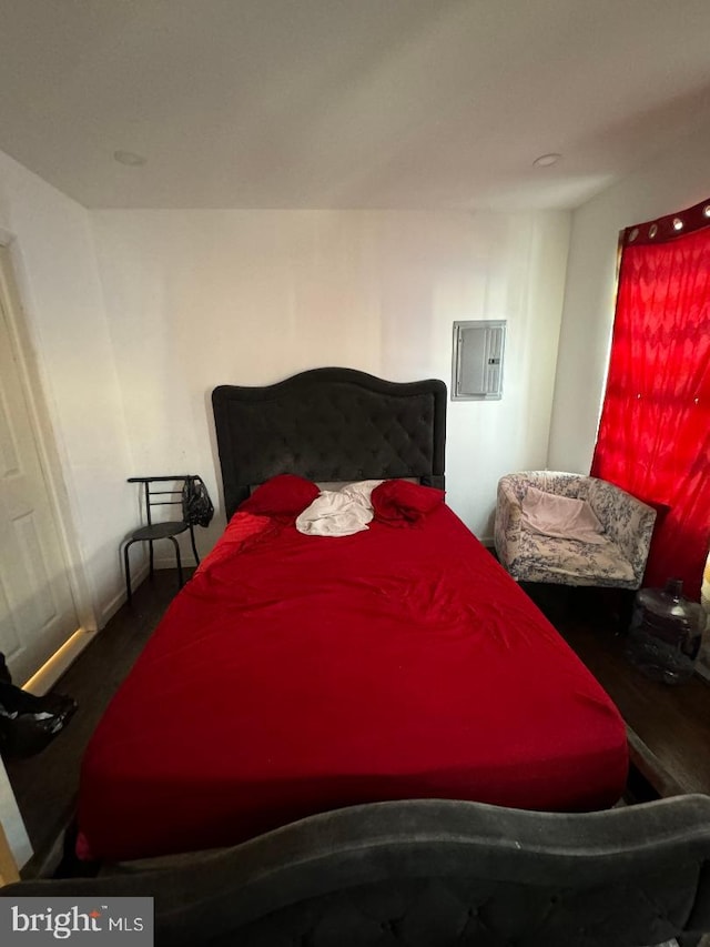 bedroom with hardwood / wood-style flooring and electric panel