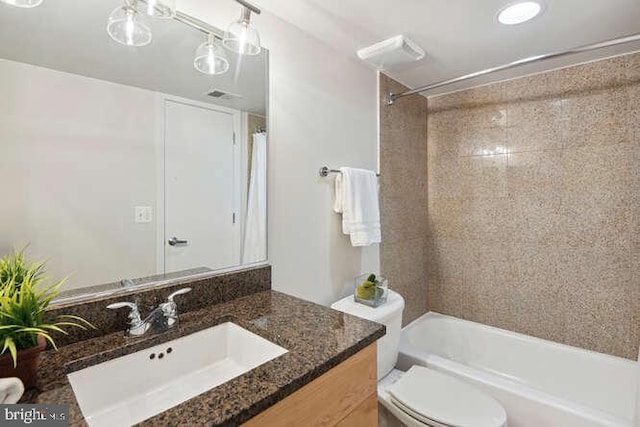 full bathroom with vanity, toilet, and tiled shower / bath combo