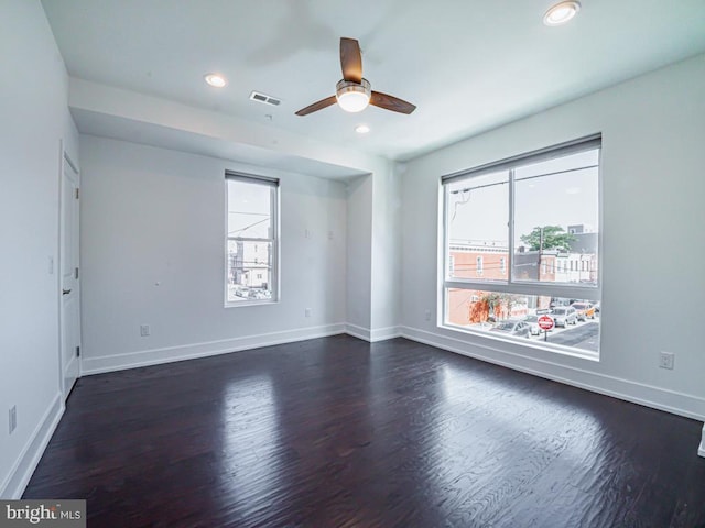 unfurnished room with dark wood-type flooring and ceiling fan