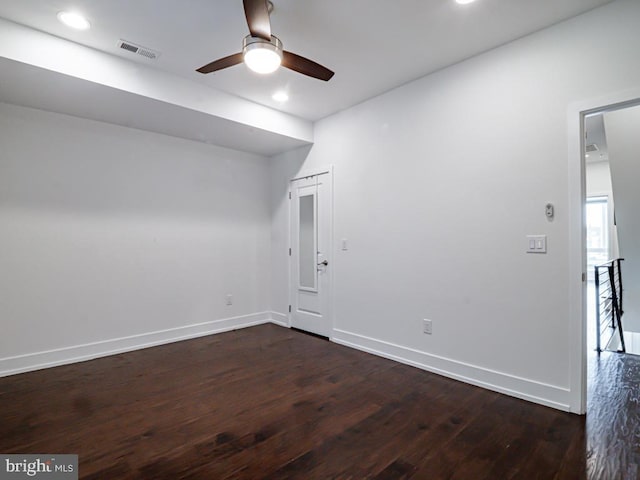 spare room with dark hardwood / wood-style flooring and ceiling fan