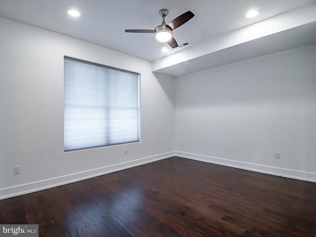 empty room with dark hardwood / wood-style floors and ceiling fan