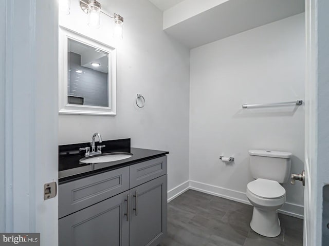 bathroom featuring hardwood / wood-style flooring, vanity, and toilet