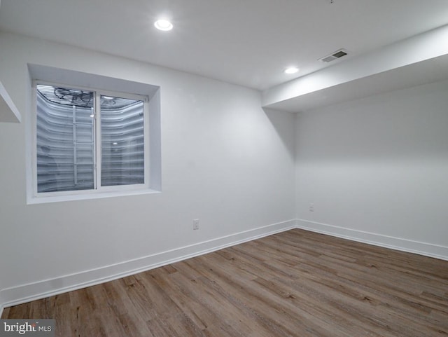 unfurnished room with wood-type flooring