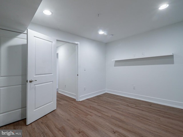 basement with hardwood / wood-style flooring