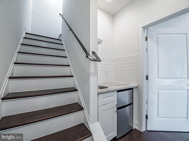 stairway with hardwood / wood-style flooring