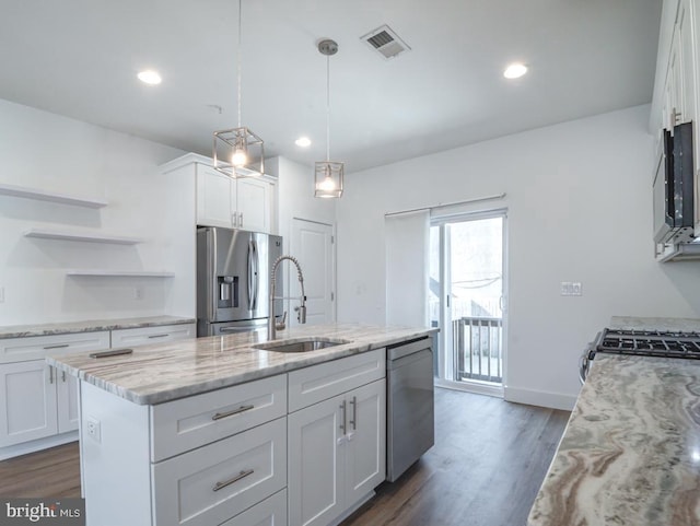 kitchen featuring sink, white cabinetry, light stone counters, an island with sink, and stainless steel appliances