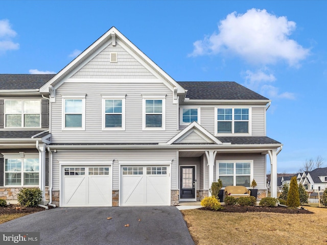 view of front of property featuring a garage and a front lawn