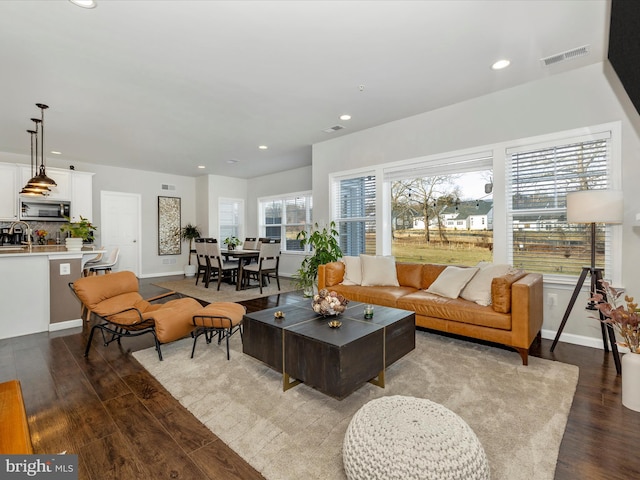 living room featuring sink and light wood-type flooring