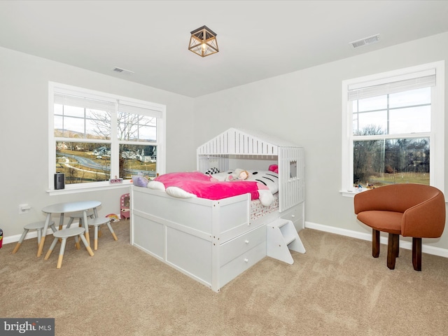 carpeted bedroom featuring multiple windows