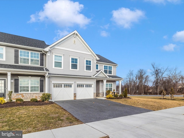 view of front of home with a garage and a front yard