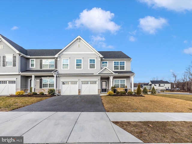 view of front of home with a garage and a front lawn