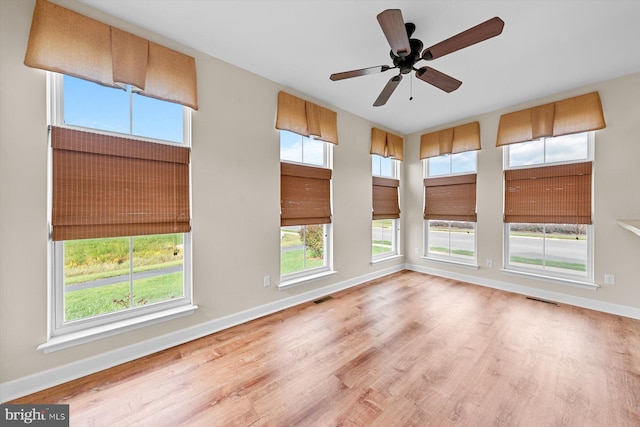 empty room featuring ceiling fan and light hardwood / wood-style flooring