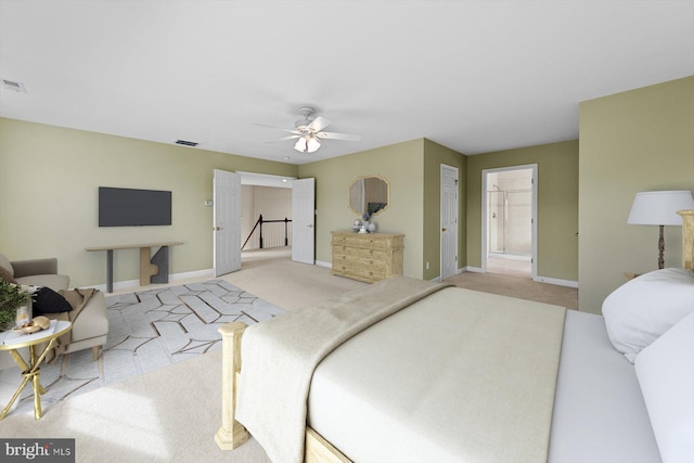 bedroom with ceiling fan and light carpet