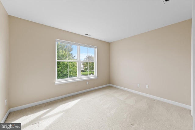 empty room featuring light carpet