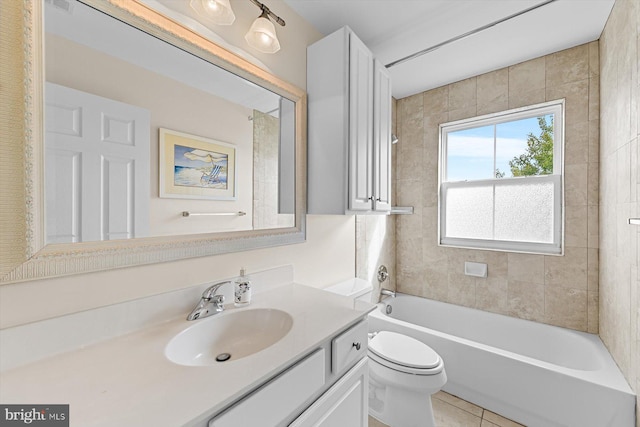 full bathroom featuring tiled shower / bath combo, vanity, tile patterned floors, and toilet