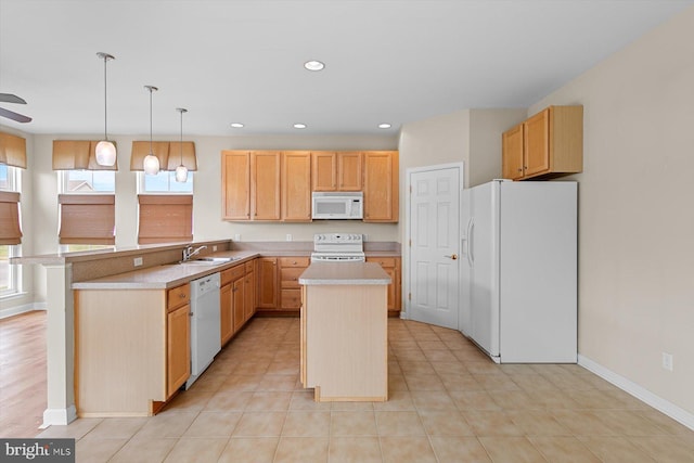 kitchen with white appliances, sink, hanging light fixtures, and a kitchen island