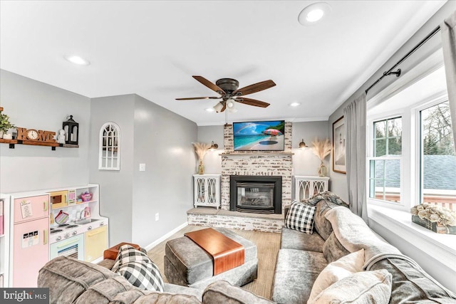 living area featuring recessed lighting, a brick fireplace, a ceiling fan, and baseboards