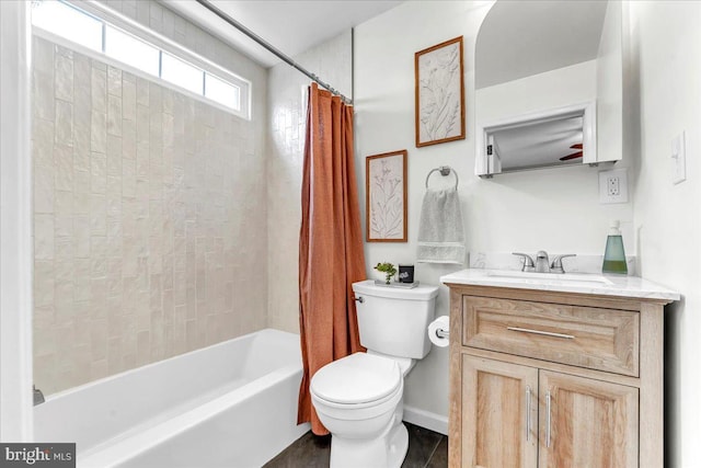 full bathroom with shower / bath combo with shower curtain, vanity, and toilet