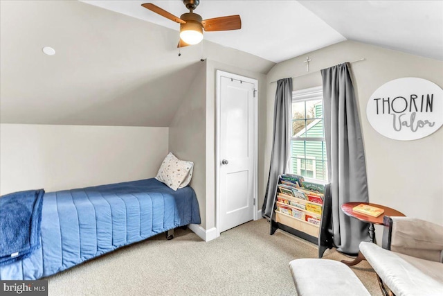 bedroom with lofted ceiling, ceiling fan, baseboards, and carpet flooring