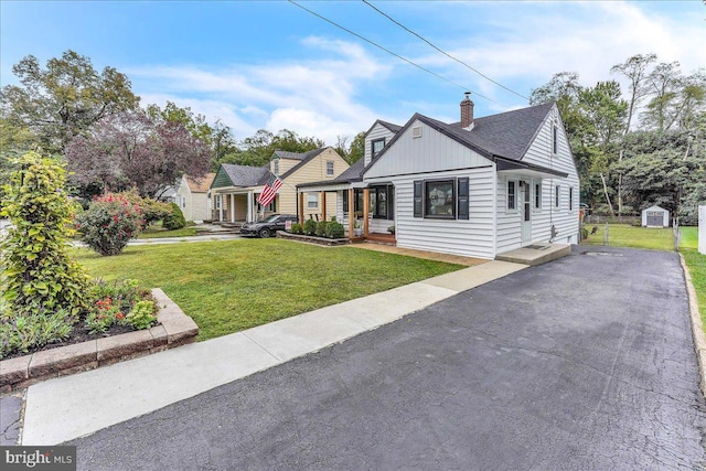 view of front of property featuring a front yard and a chimney