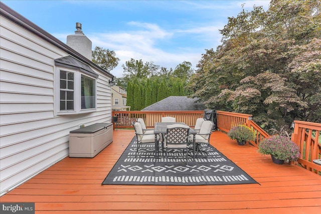 wooden deck with outdoor dining space