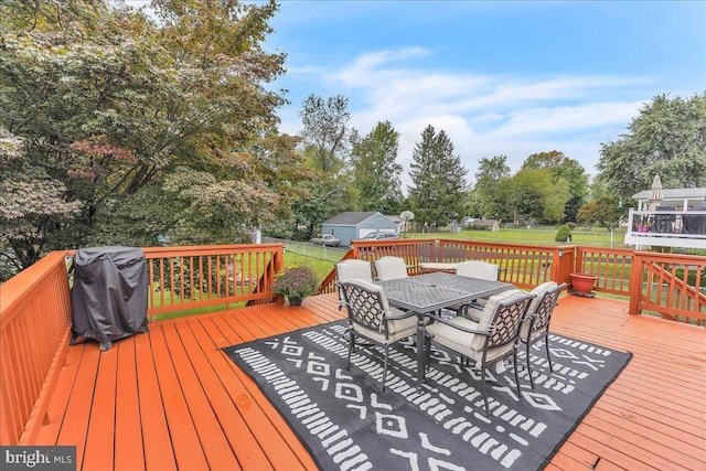 wooden deck featuring outdoor dining area