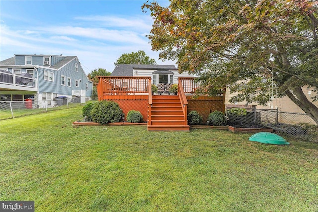 view of yard with a fenced backyard, stairs, and a wooden deck