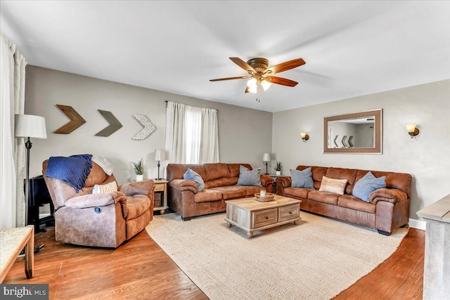 living area featuring ceiling fan and light wood finished floors