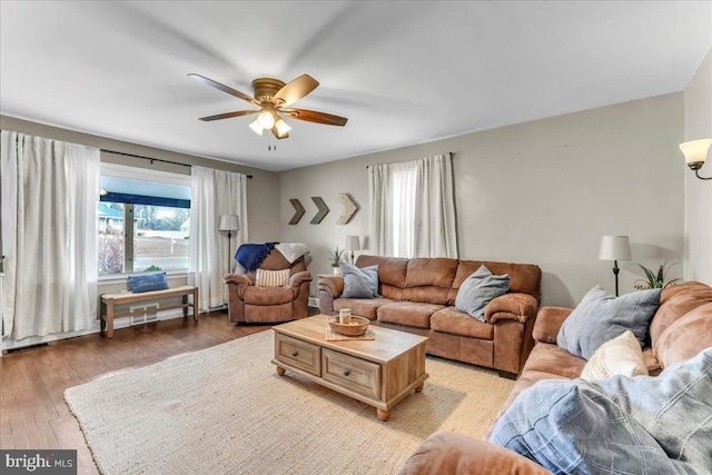 living area with ceiling fan, visible vents, and light wood-style flooring