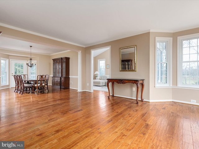 interior space featuring a notable chandelier, plenty of natural light, and light wood-style flooring