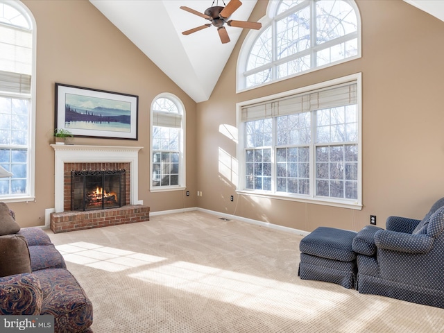 living area with carpet, baseboards, high vaulted ceiling, a fireplace, and ceiling fan