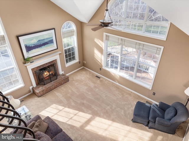 carpeted living room featuring visible vents, baseboards, a brick fireplace, and vaulted ceiling