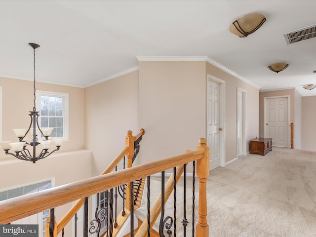 hall featuring visible vents, an upstairs landing, light carpet, and crown molding