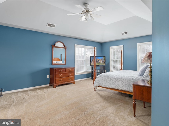 bedroom featuring visible vents, baseboards, carpet, lofted ceiling, and a raised ceiling